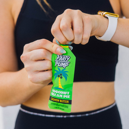 Person holding a green 'Party Pump' snack package with a blurred background