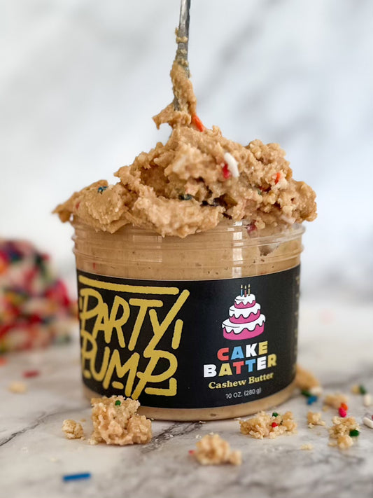 A delightful jar of cake batter flavored cashew butter, generously topped with colorful sprinkles, inviting for a delicious  adventure.